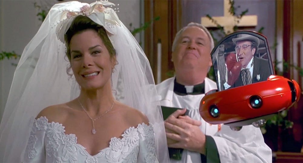 Still from the film Flubber. Robin Williams' character appears at his own wedding via a live-streamed video on a flying robot.