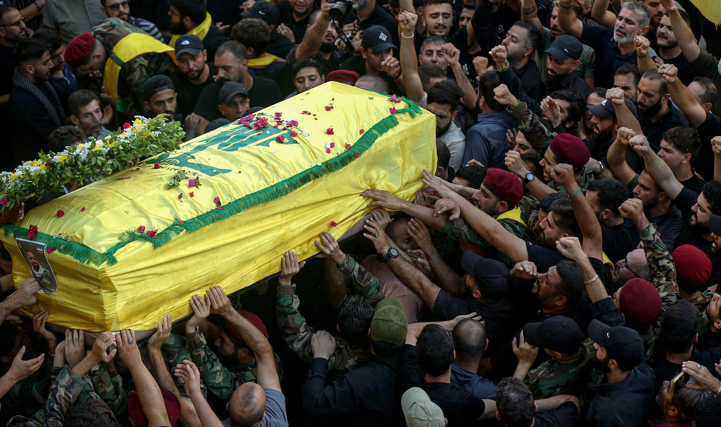 2Y4J099 18 September 2024, Lebanon, Beirut: Hezbollah supporters carry the coffin of a victim who was killed in electronic pagers explosion, during a funeral procession in Beirut southern suburb. Thousands people were wounded in the cyberattack and 12 were killed so far in the latest toll announced by the ministry of health. Hezbollah has blamed Israel for the detonations on 17 September and promised retaliation. Several of its fighters, as well as high-ranking representatives and members of the Radwan Force, an elite unit within the group, are said to be among the victims. Photo: Marwan Naamani/dpa