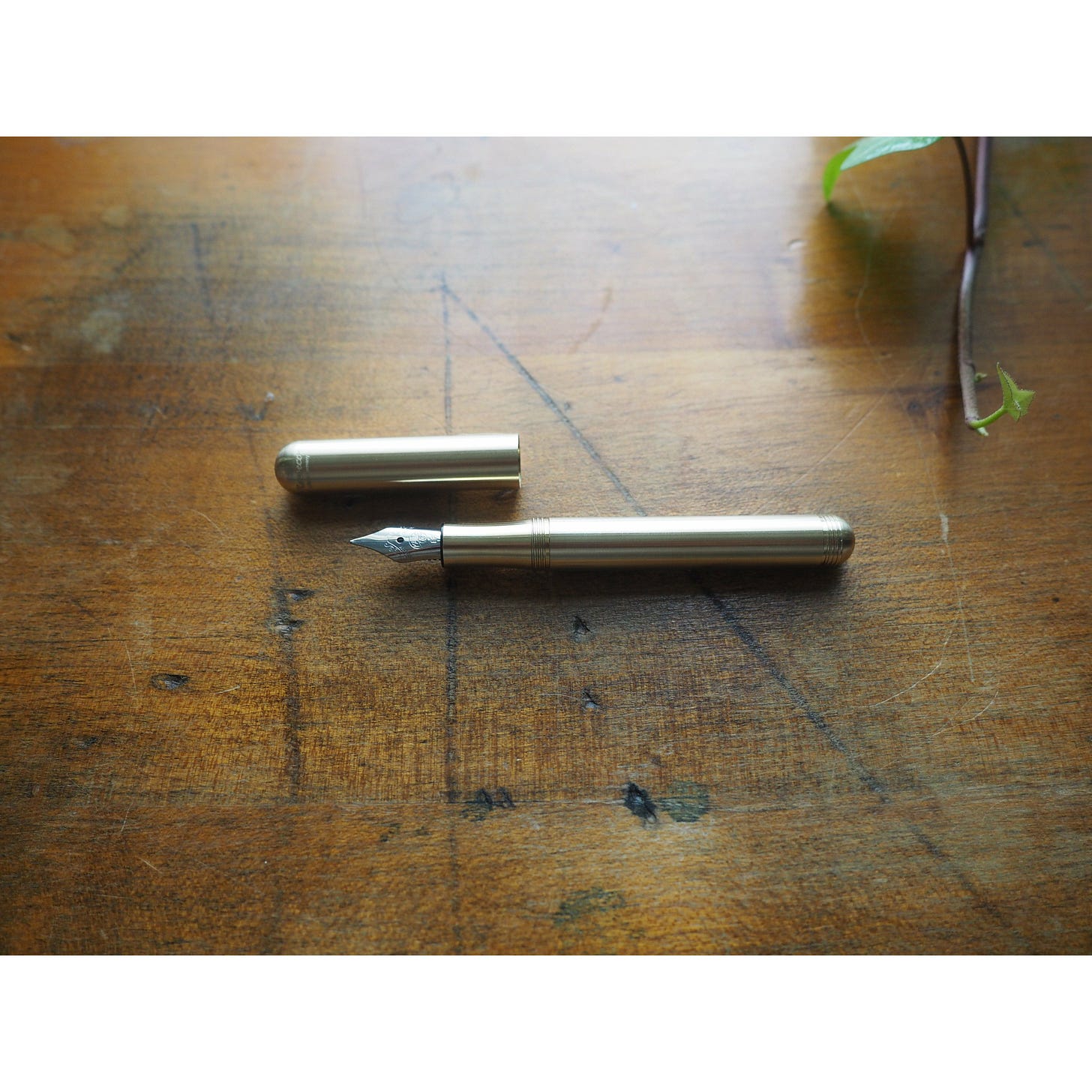 A very tiny, minimal brass fountain pen.