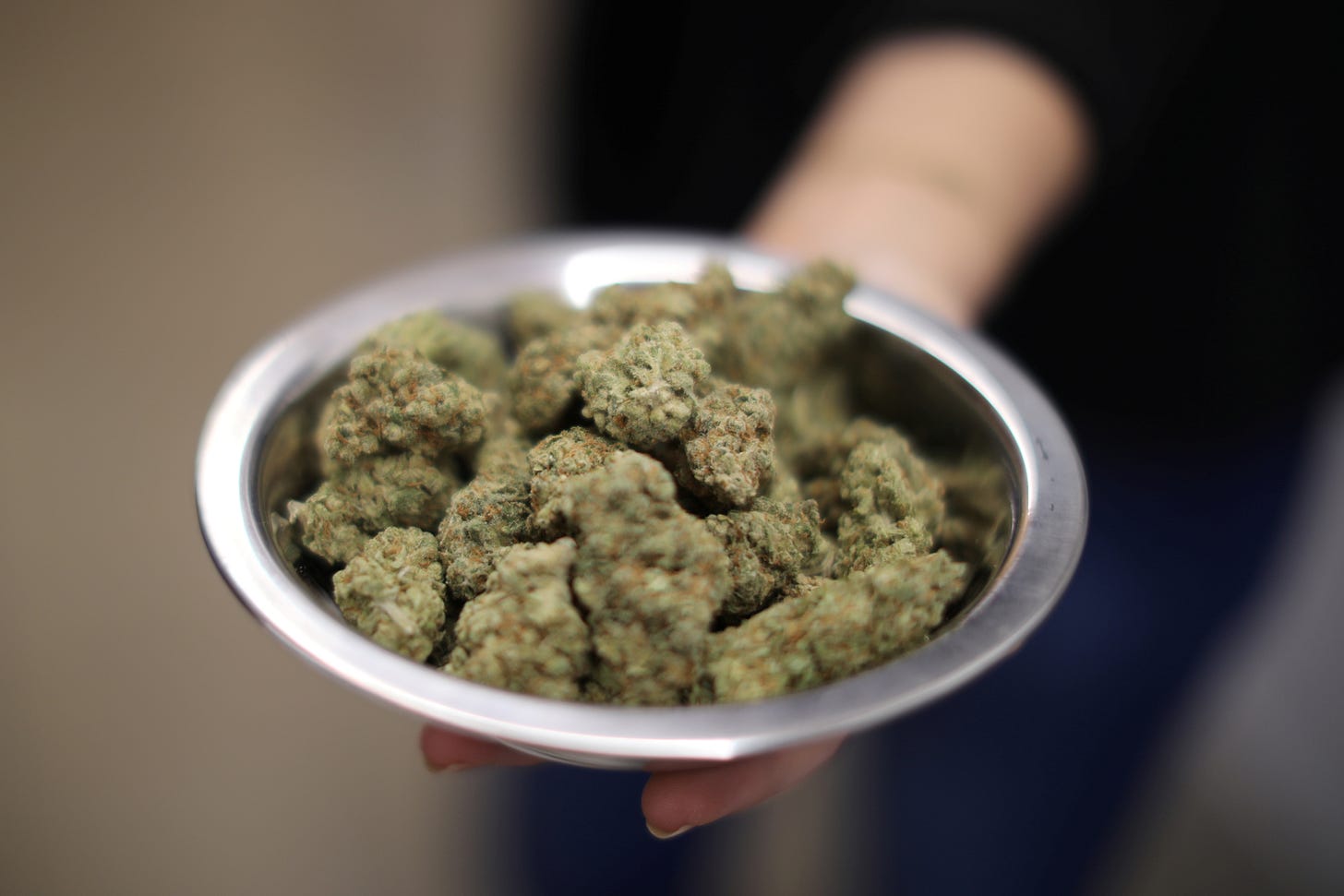 A woman holds marijuana for sale at the MedMen store in West Hollywood