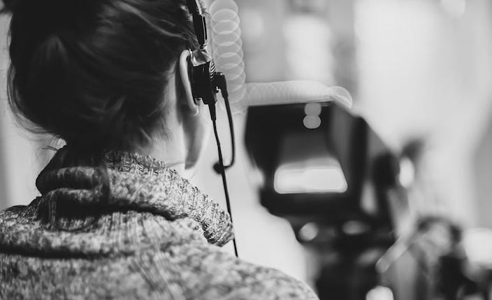 woman filmmaker looking at monitor