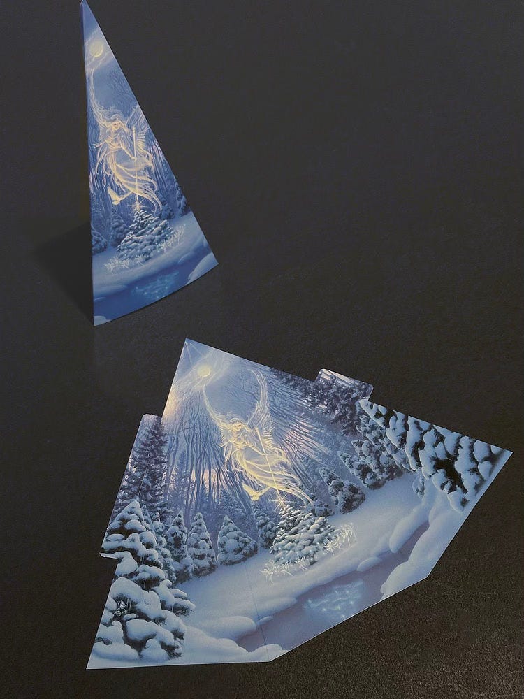 Two images of the holiday card on a black background. One is the card folded as a tall pyramid. The other is the card as printed flat before being folded.