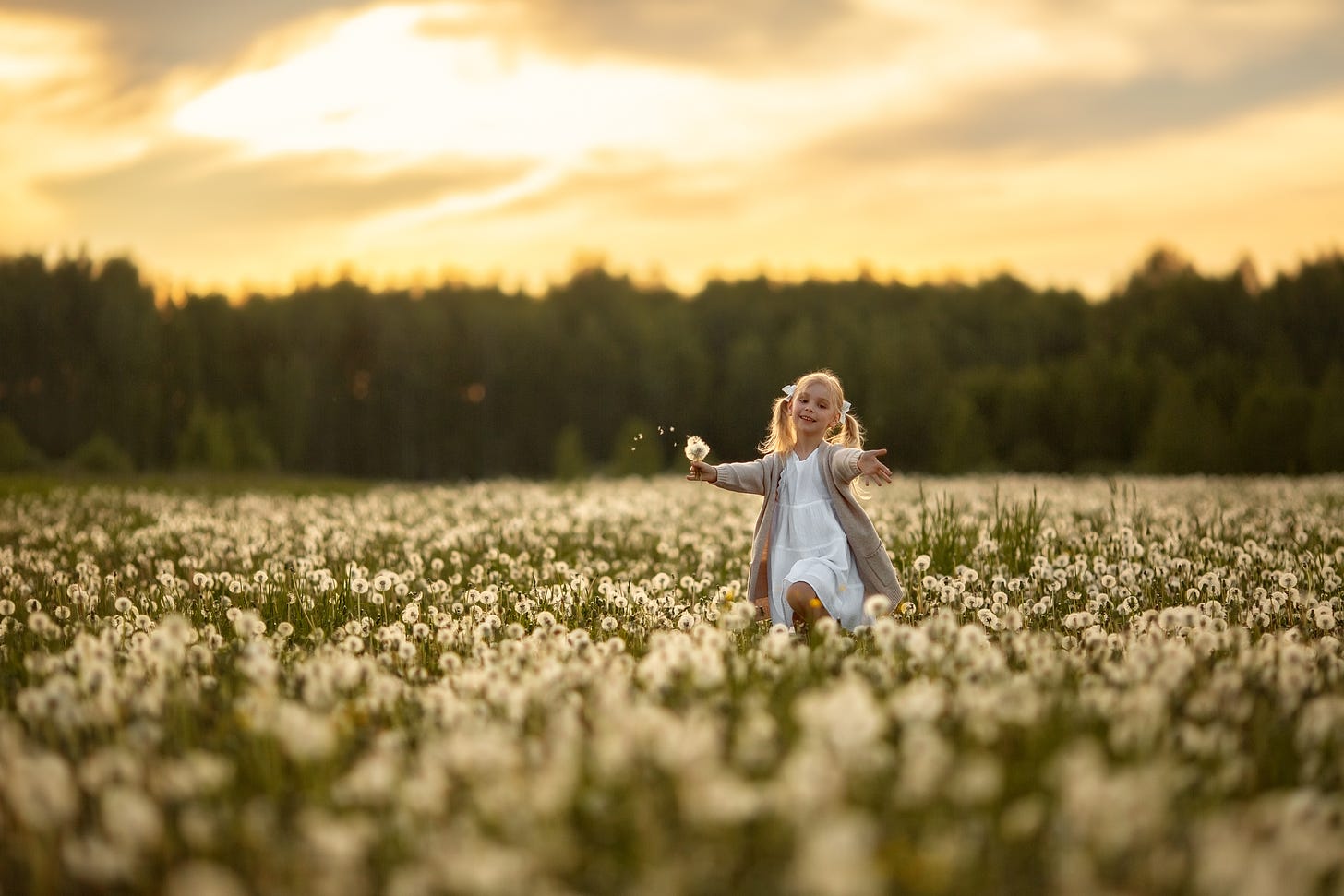 A young girl running through a field of dandelions