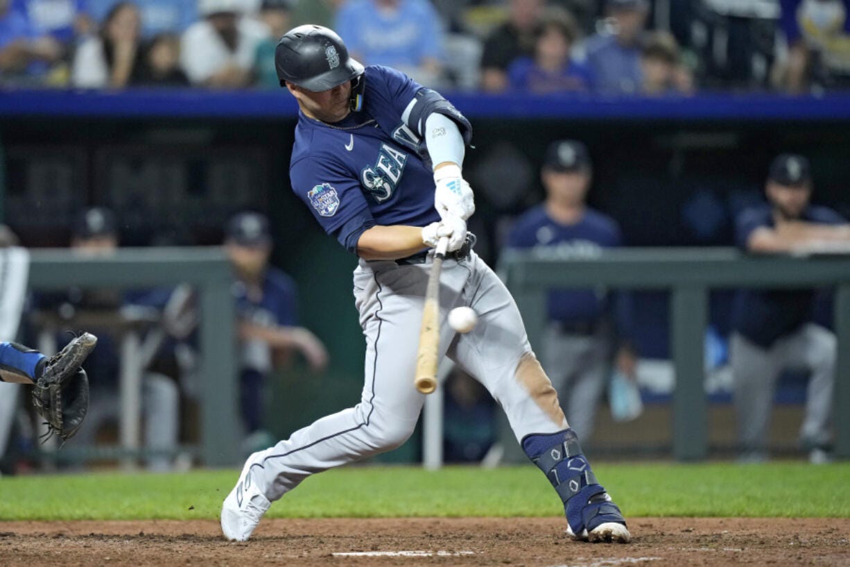 Seattle Mariners' Ty France hits a two-run single during the 10th inning of a baseball game against the Kansas City Royals Tuesday, Aug. 15, 2023, in Kansas City, Mo. The Mariners won 10-8 in 10 innings.