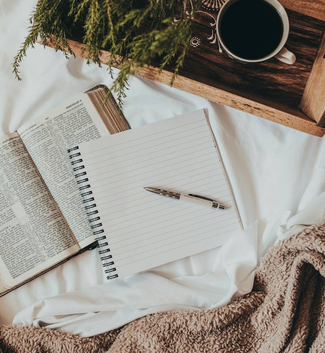 white notebook on white textile