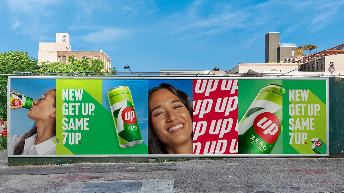 Image shows outdoor advertising for 7UP featuring its new branding, including an image of the can, text that reads 'New Get Up. Same 7UP' and an image of the word 'up' repeated as a pattern
