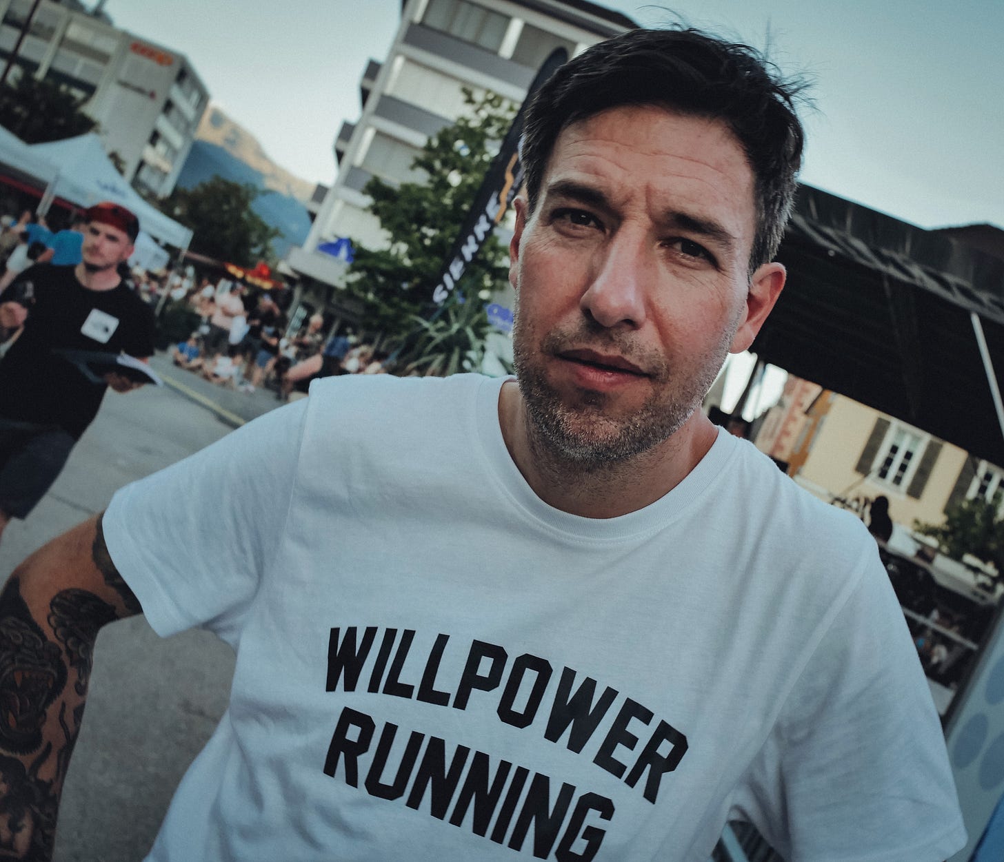 The author looking into the camera wearing a white willpower shirt