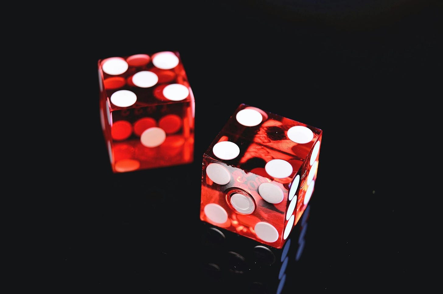 Two six-faced dice on black background