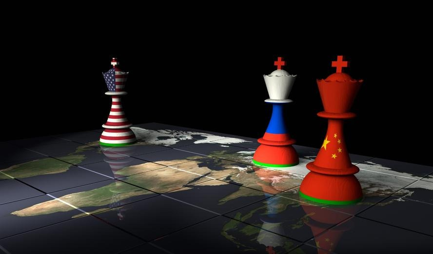 World map with chess pieces with flags of Russia, China, and the United States, photo by theasis/Getty Images