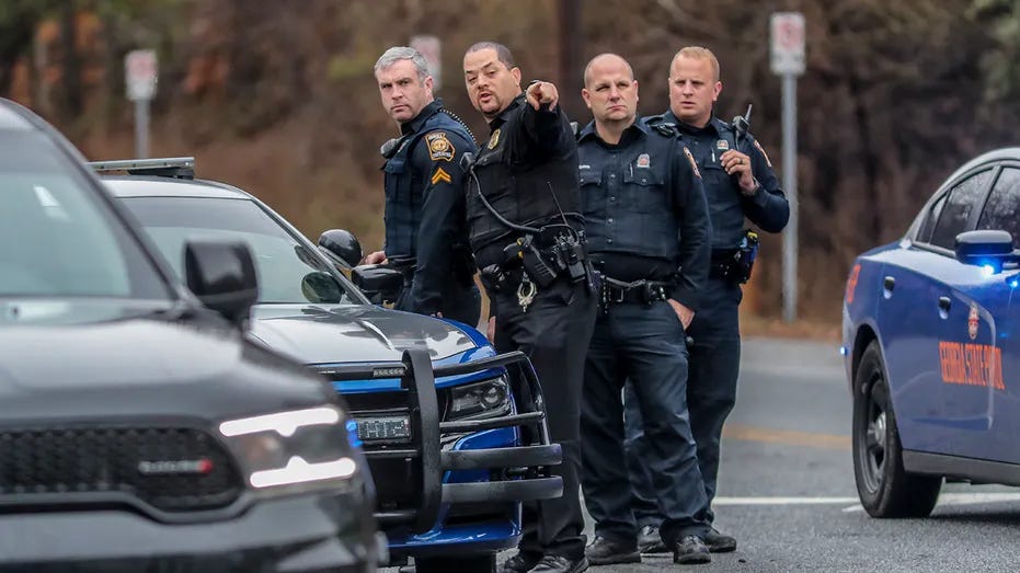 Georgia state troopers stand with a DeKalb, Ga., police officer on Constitution and International Park in Atlanta on Wednesday, Jan. 18, 2023. 