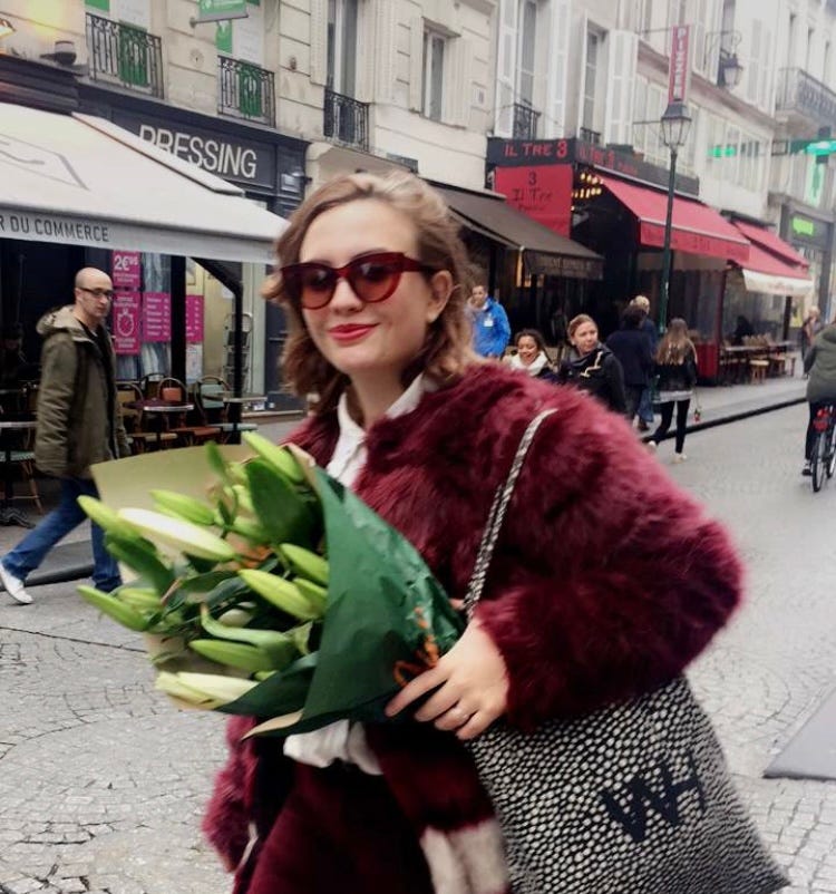 Larissa Fantini holding flowers in Paris