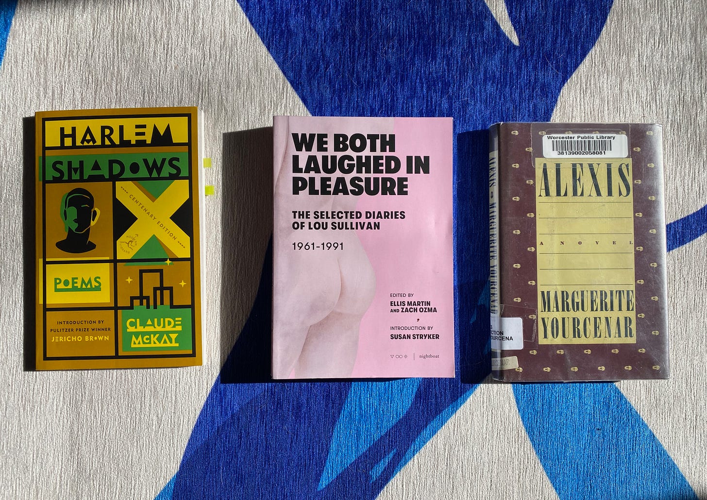 Harlem Shadows, We Both Laughed in Pleasure, and Alexis in a row on a blue and white rug.