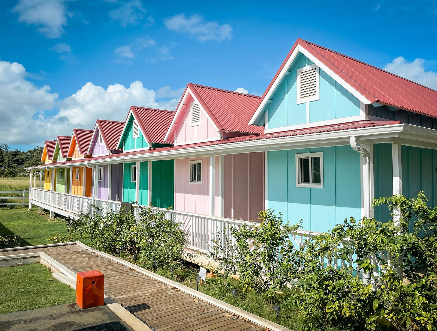 image of facade of 7 colorful houses all in a row