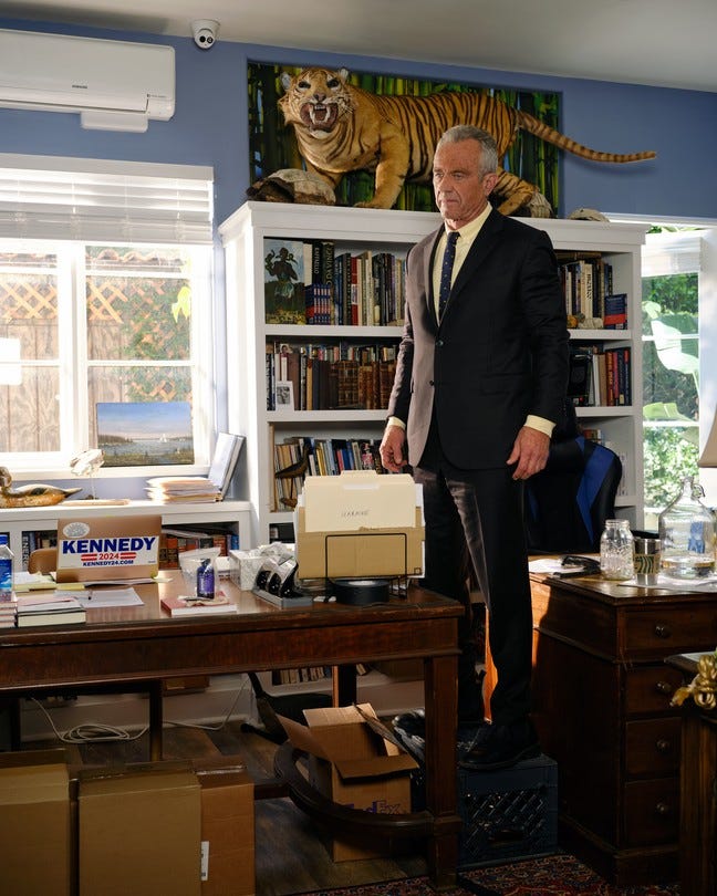 Picture of Robert F. Kennedy Jr standing near a desk and a full bookshelf in his office in Los Angeles