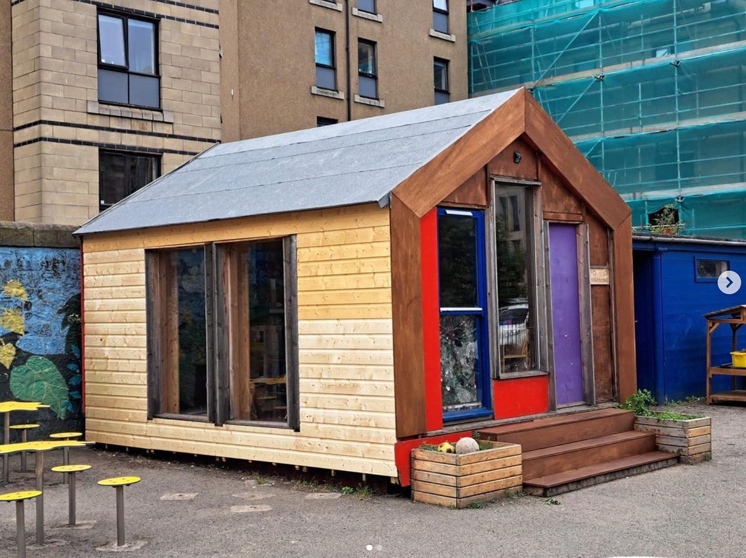 A one storey pitched roof refurbished outdoor classroom set in a school playground
