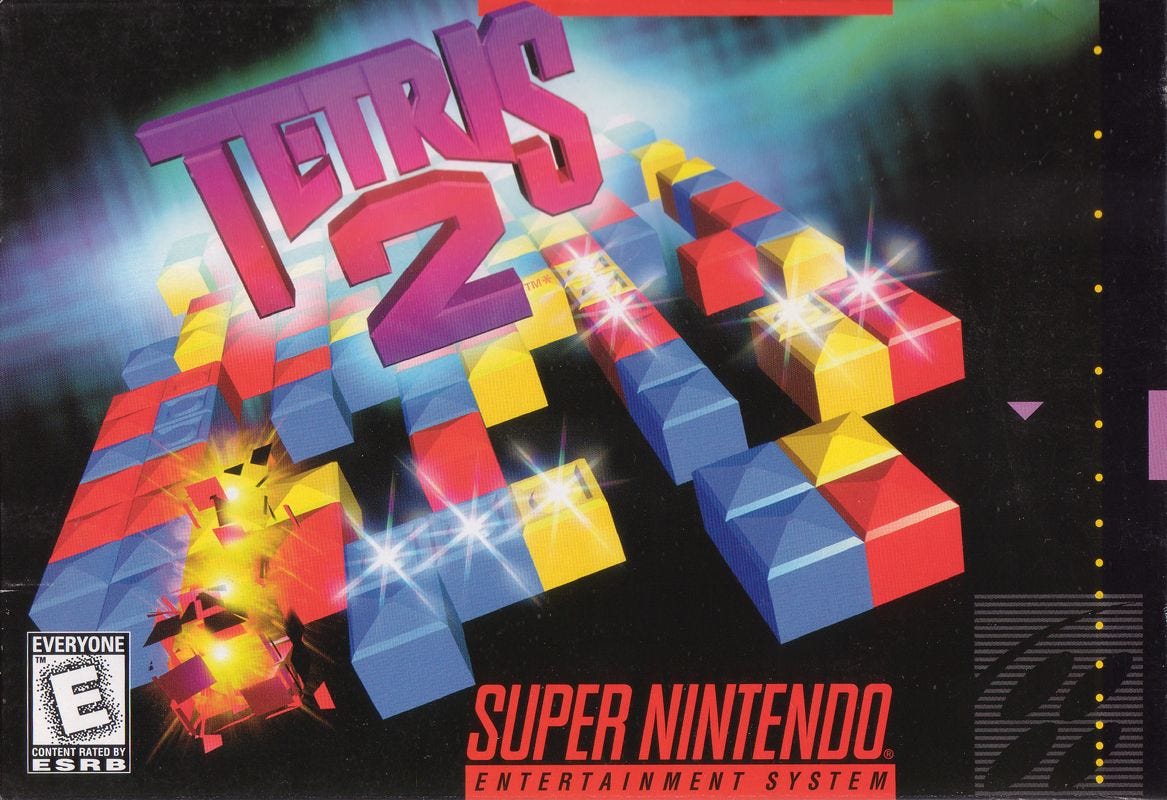 The SNES box art for Tetris 2, known as Tetris Flash in Japan, featuring falling Tetriminos and a line being cleared in an unfamiliar way, given it's vertical and just three blocks long.
