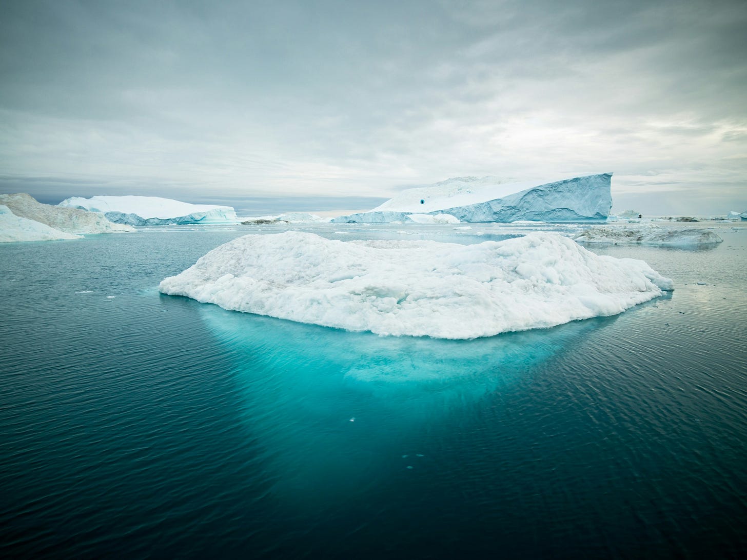 photo of iceberg showing side view of how deep they are underwater