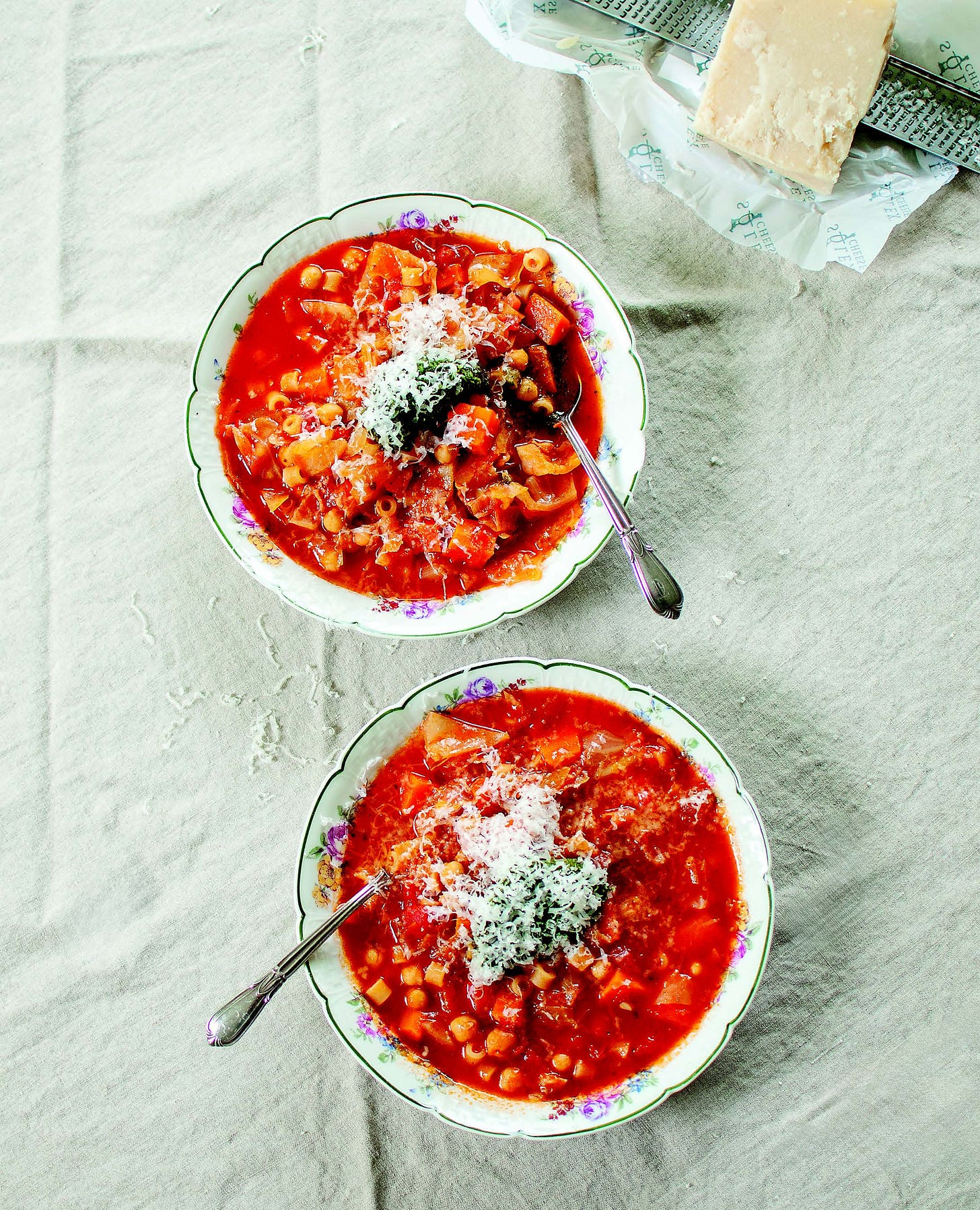 Two bowls of minestrone-ish soup with parmesan on top