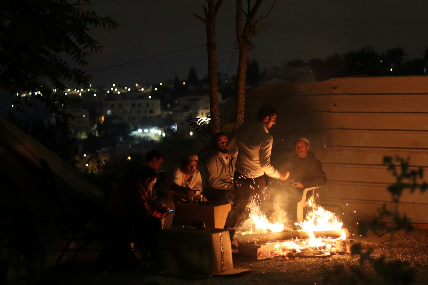 a big bonfire and Jewish boys around a small one
