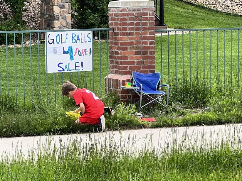 Kid selling golf balls