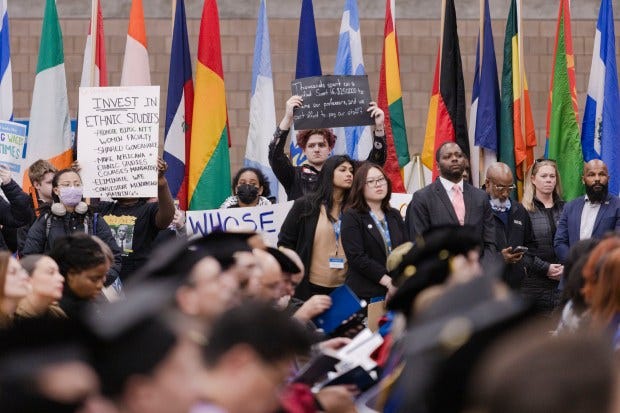 People protest tuition costs during Chancellor Suarez-Orozco's Inauguration at UMass Boston's Clark Athletic Center. (Libby O'Neill/Boston Herald)