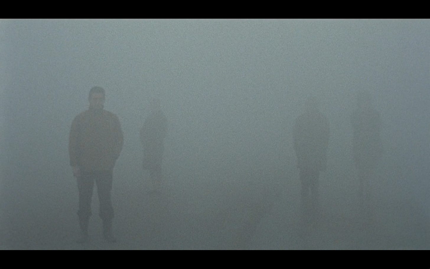 Figures Fade into Grey Fog