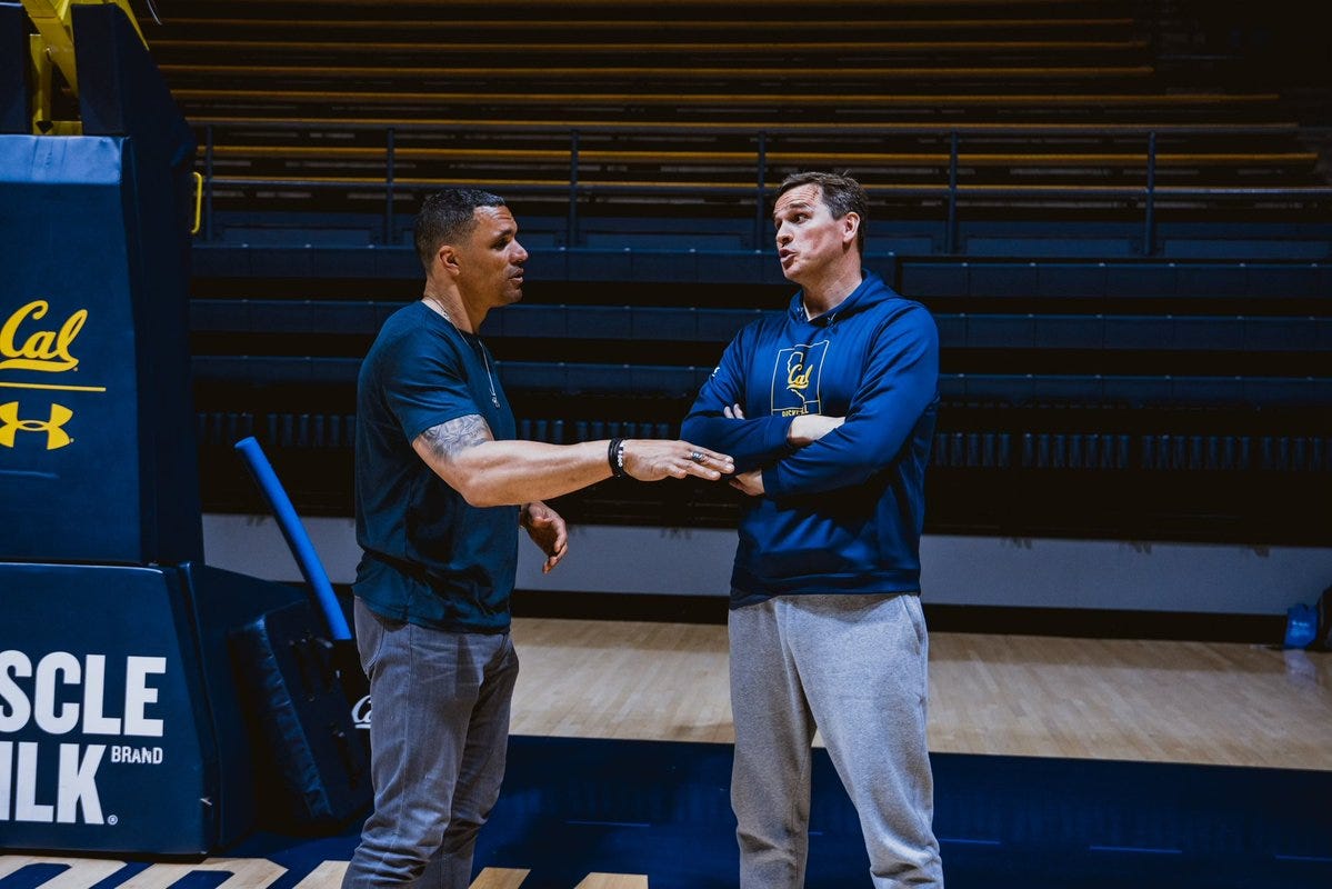 Tony Gonzalez (left) and Cal head coach Mark Madsen talk on the basketball court inside of Haas Pavilion.