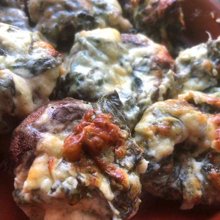 garlic, cheese and spinach stuffed mushrooms - basically a lot of gooey cheesiness