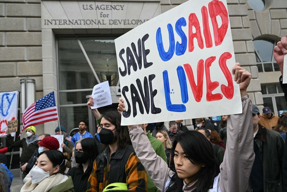 People protest outside of the headquarters for United States Agency for International Development after Donald Trump's billionaire friend and advisor Elon Musk vowed to destroy the agency.