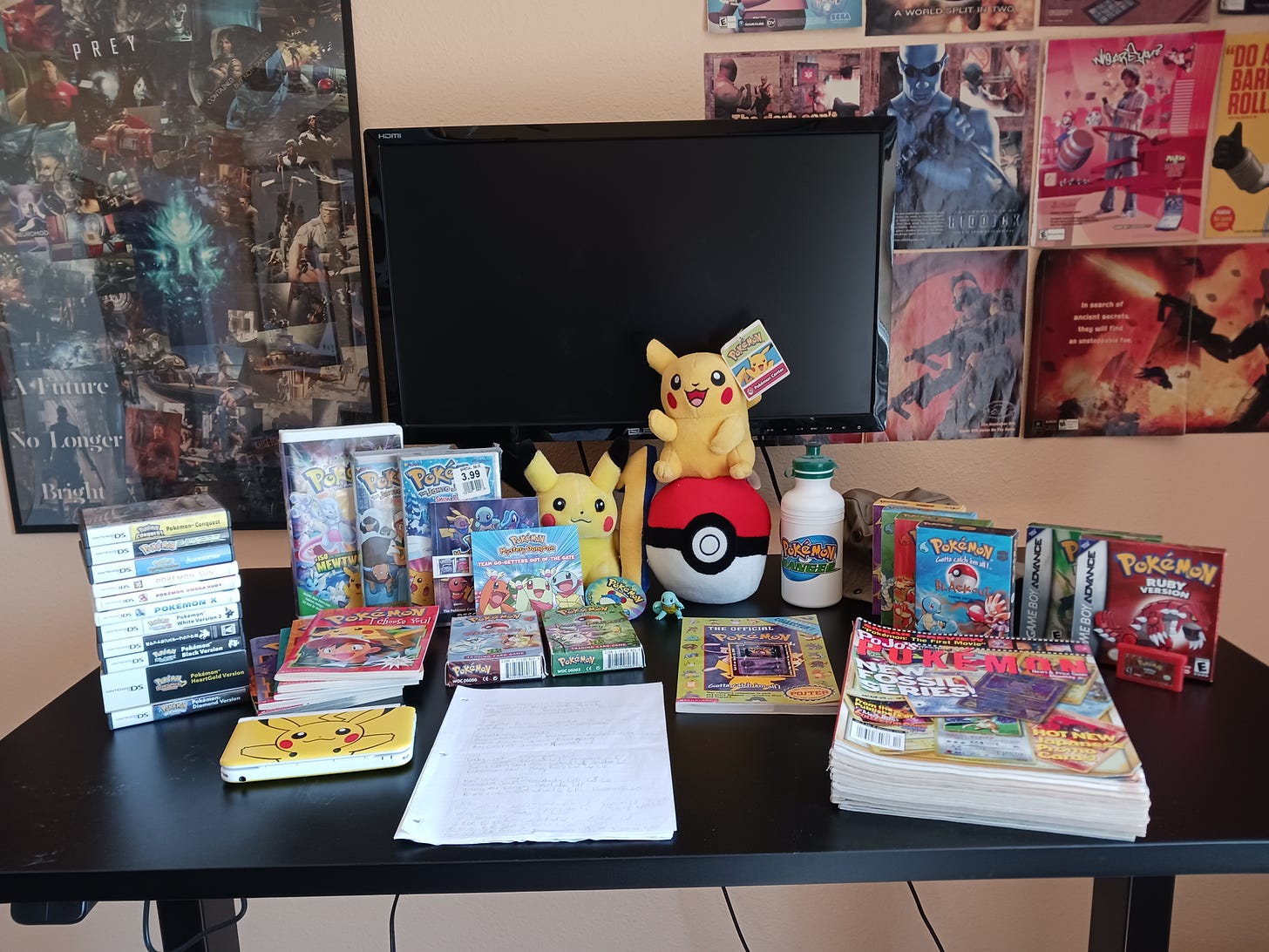 Ryan still has a ton of awesome Pokémon items from his childhood! Pictured here are video games, VHS videos, books, TCG deck boxes, Pikachu plush toys, a Pokémon Ranger water bottle, magazines, a Pikachu 3DS console, and a hand-written note by Ryan from his days playing Pokémon Ruby.
