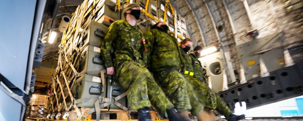 Royal Canadian Air Force personnel load non-lethal and lethal military aid at CFB Trenton, Ontario on Monday, March 7, 2022. Sean Kilpatrick/The Canadian Press. 
