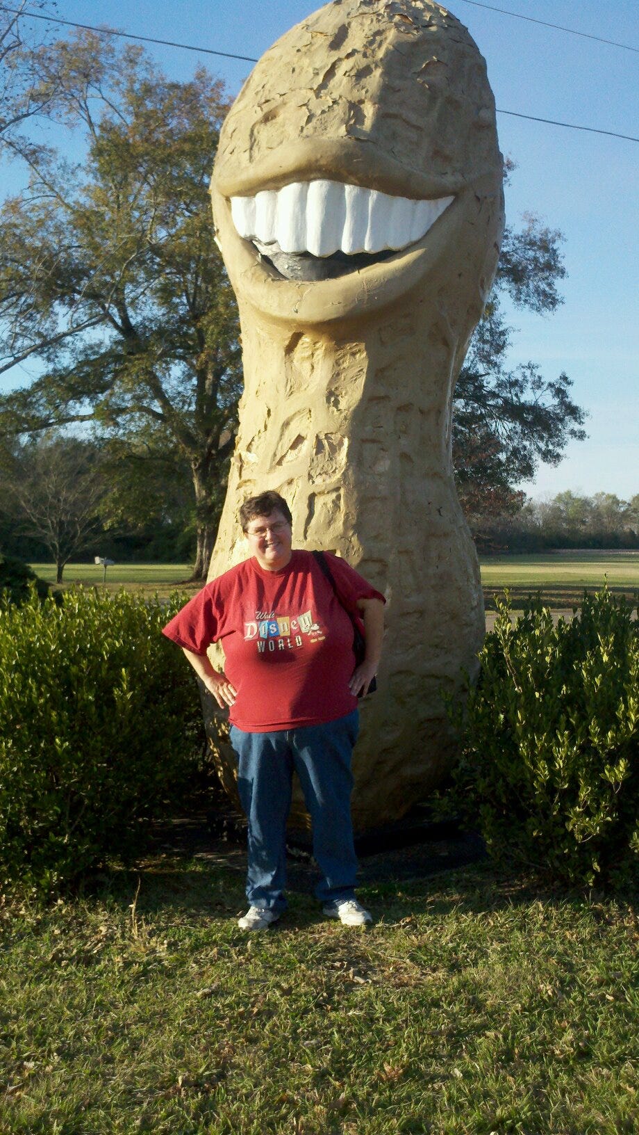 Annette in Disney T-shirt standing in front of enormous peanut with giant Jimmy Carter-style teeth