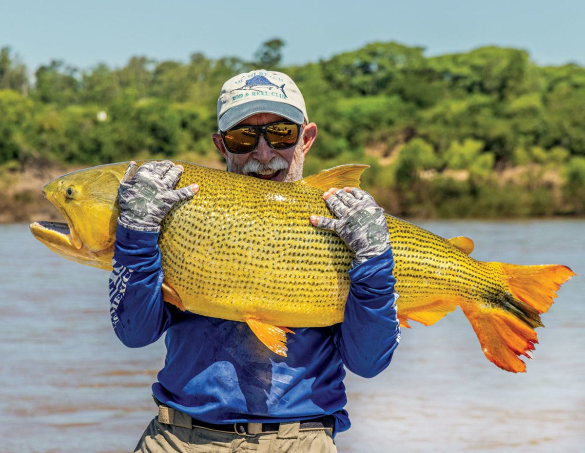 World-record holder Marty Arostegui poses for a quick photo with a giant golden dorado. 