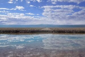 An abandoned road and brine transitional pool at the margin of the Salar de Atacama Halite Nucleus.