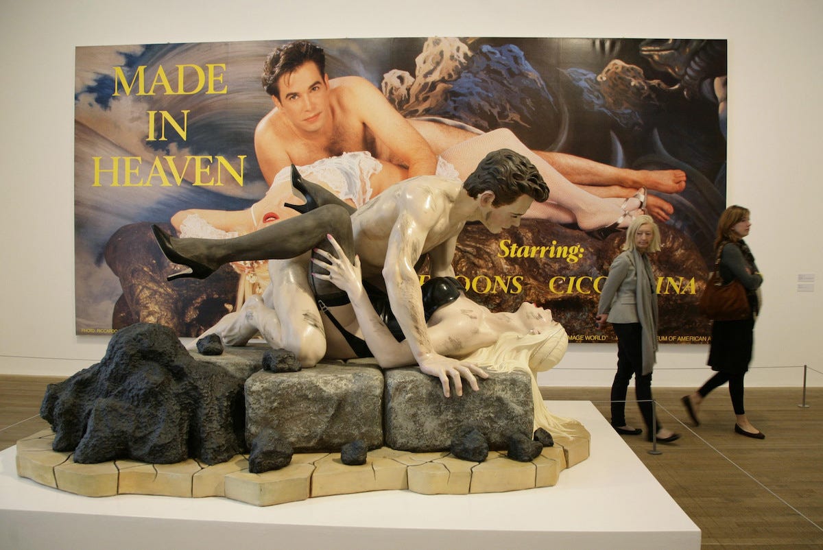 A gallery with a sculpture of a white man fornicating with a white woman atop a boulder, as well as a painting of a similar subject that contains the text 'MADE IN HEAVEN.' Two museum visitors walk by the works.