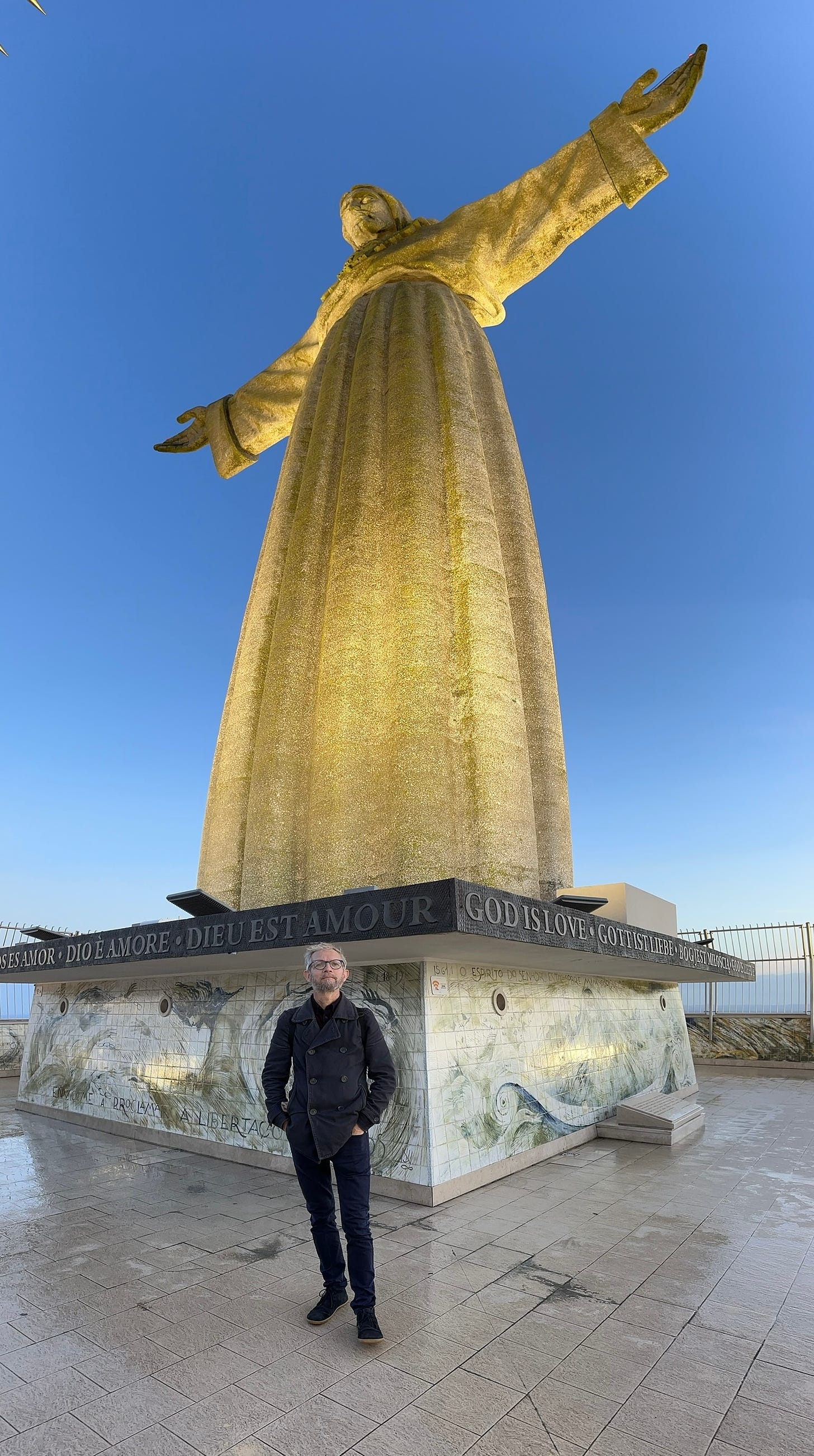 Ant stands under the Christus Rei statue in Lisbon