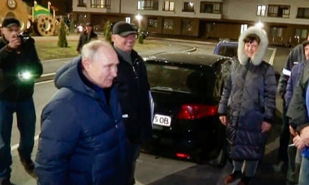 Screengrab from video released by Russian TV on 19 March of Vladimir Putin talking to residents in Mariupol.