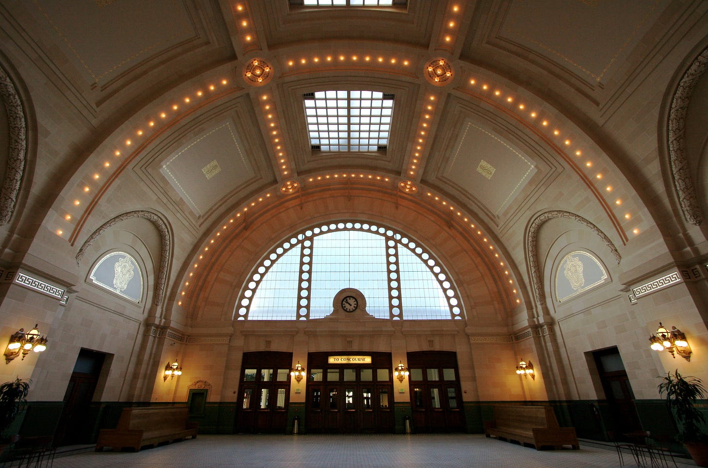 Interior shot of King Street Train Station in Seattle directed toward the ornate ceiling architecture.