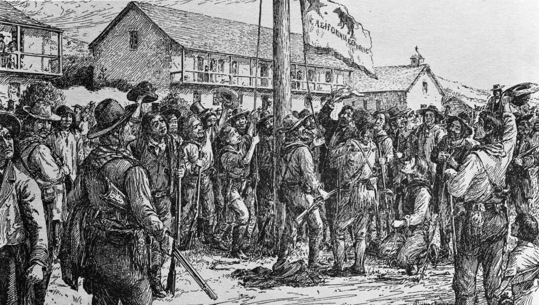 Photograph of an illustration showing the raising of the Bear Flag over Sonoma, June 14, 1846. A large group of men, most of which are carrying rifles, is gathered around a thick wooden pole at center. The men are wearing leather mountain man-type clothing, and several have taken off their hats to celebrate. The California Republic flag, complete with grizzly bear, star, and stripe, is being raised on the pole. In the background is the home of General Vallejo, an army barracks, and a church.