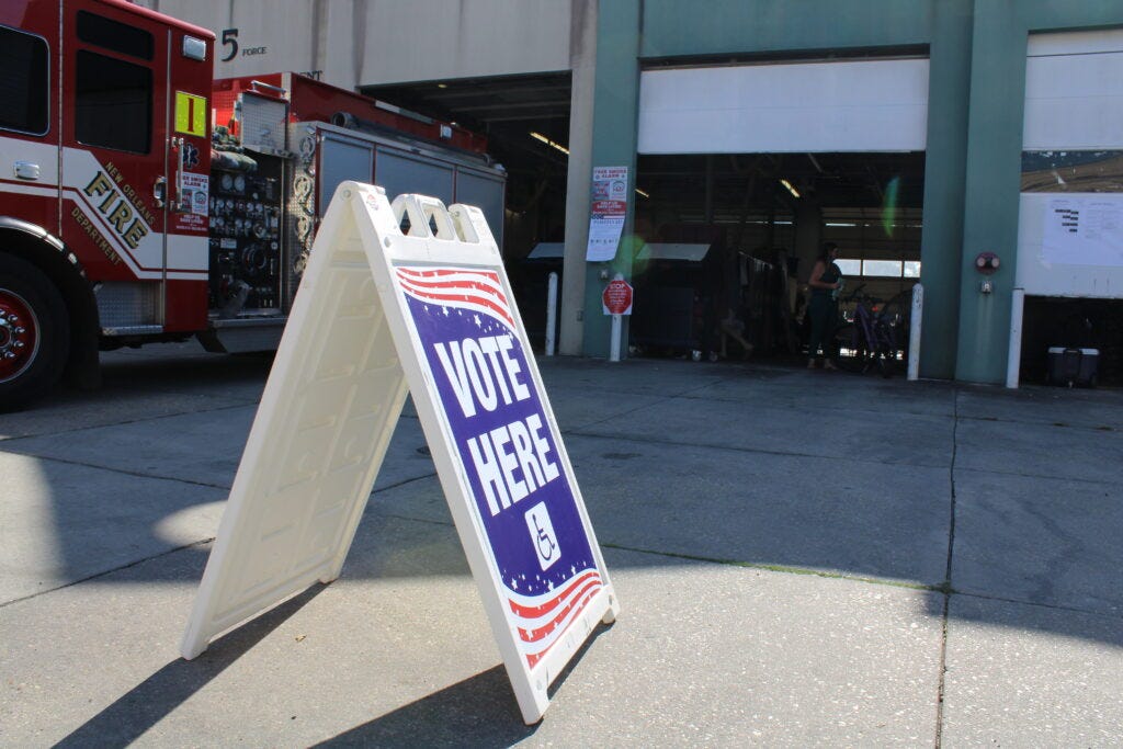 A sign marks a polling site with multiple precincts at a fire station in New Orleans' Garden District
