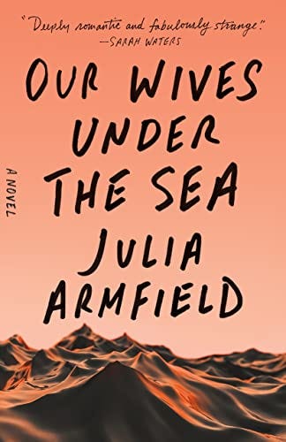 The cover of Our Wives Under the Sea, which shows an orange-tinted ocean.