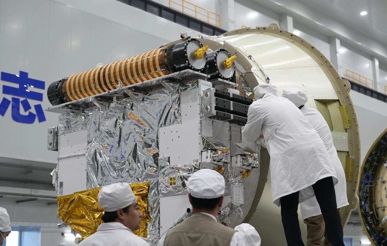 The two Guangchuan satellites being inspected on Zhuque-2E’s payload adapter before fairing encapsulation.