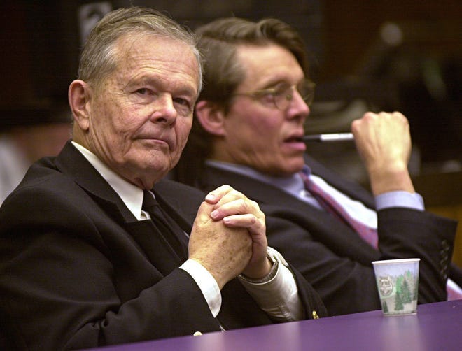 Former priest John Geoghan, left, is shown at his trial, Thursday, Jan. 17, 2002, in the Middlesex Superior Court, in Cambridge, Mass. At right is his attorney Geoffrey Packard. [AP, file / John Blanding]