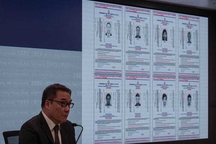 A person standing in front of a large screen

Description automatically generated