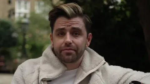 BBC Jarryd Nurden, a man with brown and blonde hair and stubble in a cream fleece