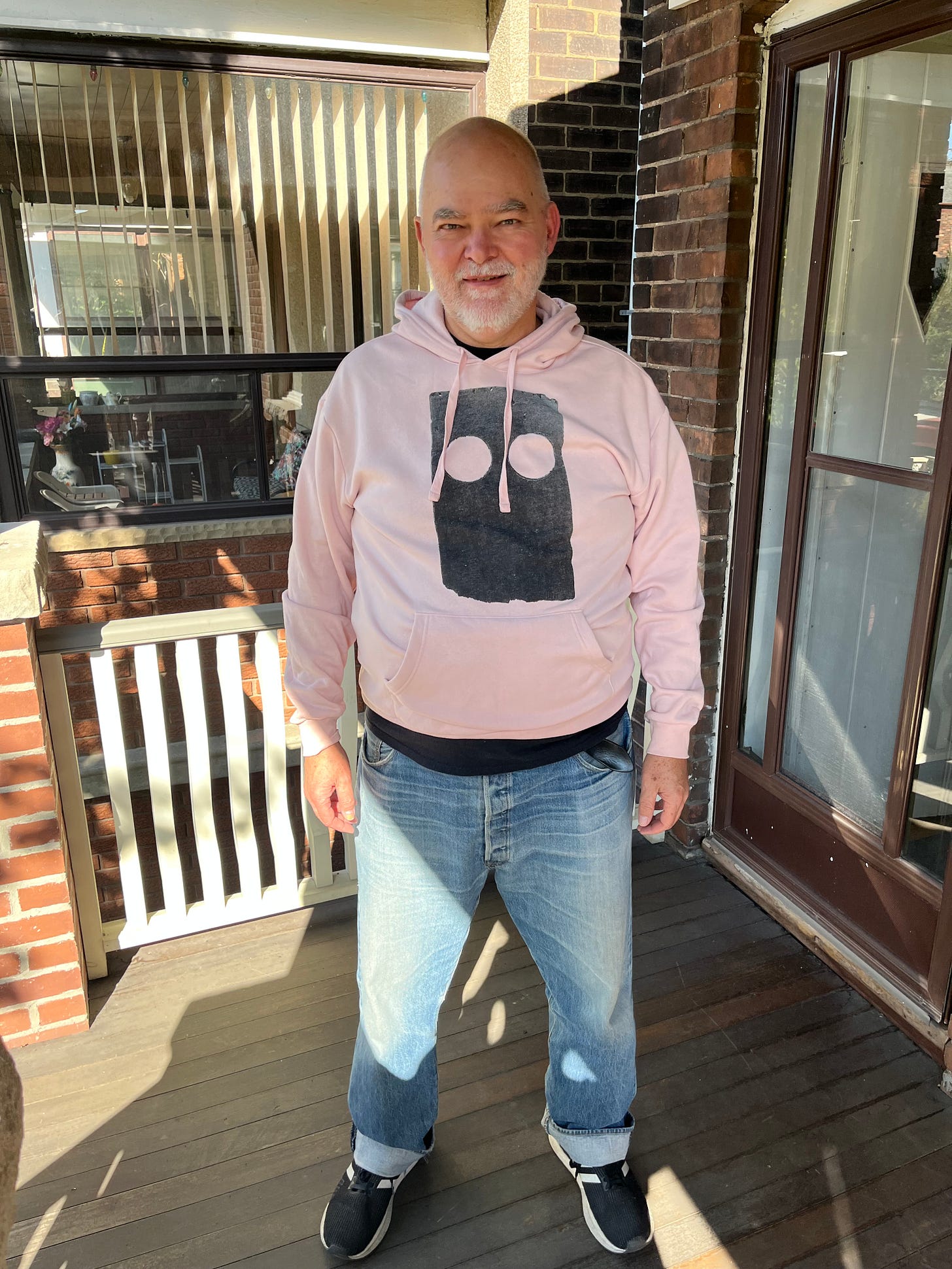 Writer Don Pyle on his porch in his new LOW sweatshirt.