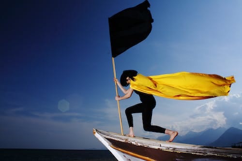 Free Woman Holding Black Flag Stock Photo