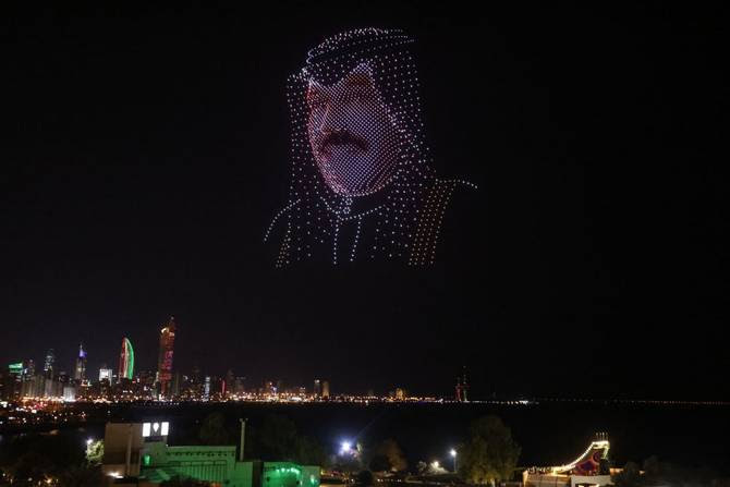 An image made out of drones in the effigy of the Emir of Kuwait Nawaf al-Ahmad al-Jaber al-Sabah, hovers above the Green Island off the coast of Kuwait City