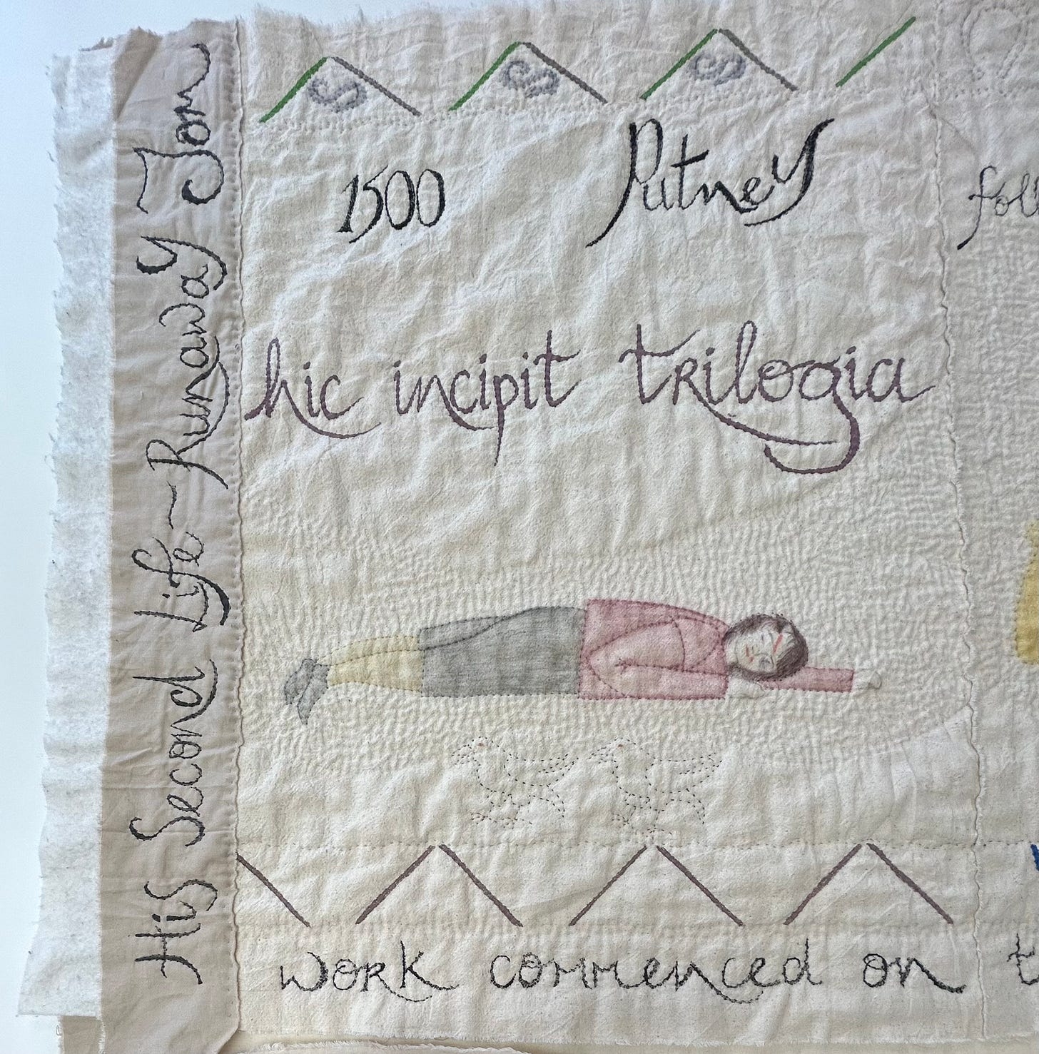 Quilted piece depicting a boy lying on the ground. Stitched in is text reading “His Second Life- Runaway Tom”; “1500 Putney”, and “hic incipient trilogia”
