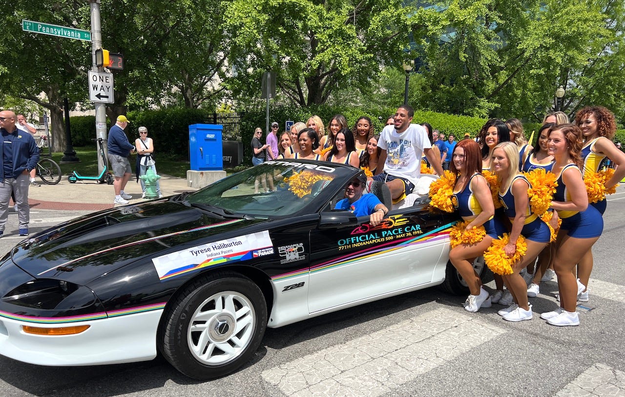 The Pacemates pose for a photo with Tyrese Haliburton in the back of his Chevy Camaro pace car.